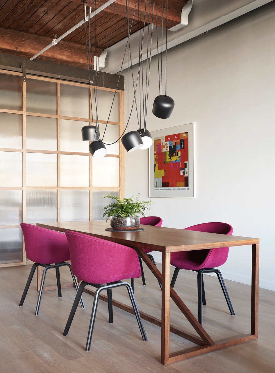 flos-lighting-hangs-over-a-bludot-dining-room-table-with-hay-dining-chairs.jpg